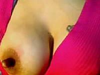 Amateur brunette demonstrates her right boob for the webcam