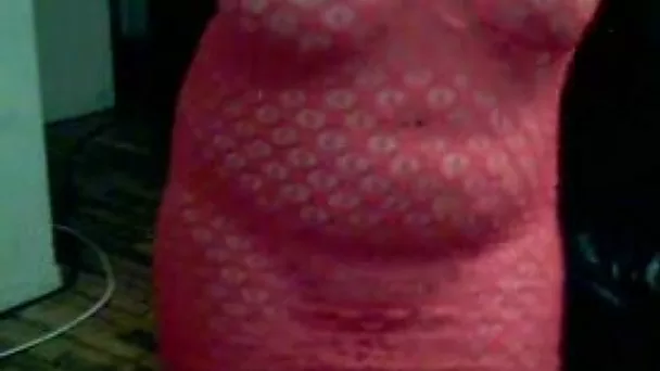 Curvaceous and bosomy amateur shows off her ass in fishnet dress