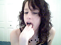 Amateur teen pokes her fingers deep in her mouth in front of a webcam