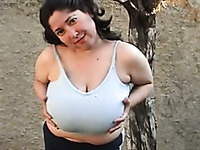 Chubby brunette milf plays with her big natural tits outdoors