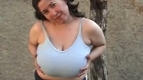 Chubby brunette milf plays with her big natural tits outdoors
