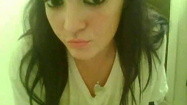 Amateur black haired webcam hoe flaunts her giant tits in white shirt