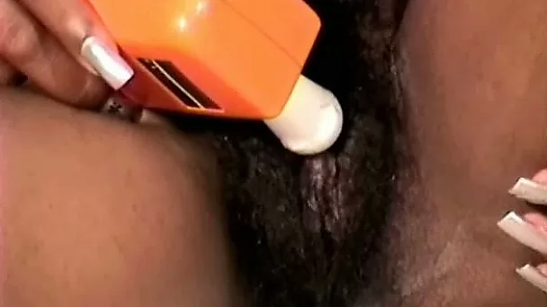 Nasty ebony wife of mine pokes her hairy cooch with vibrator
