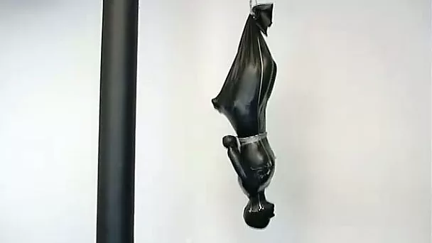 A bitch in latex overall gets suspended in BDSM scene
