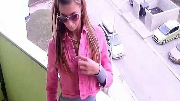 Buxom temptress in sunglasses is masturbating on the balcony
