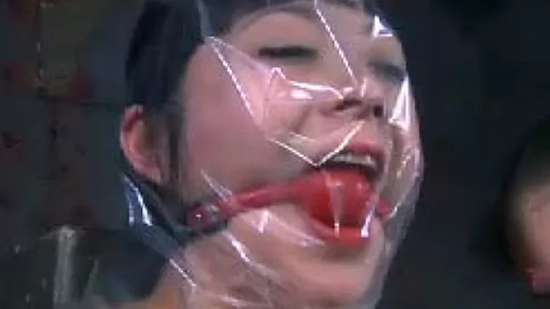 Wicked mistress puts a plastic bag over her slave's head