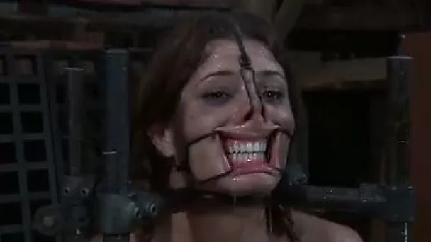Bounded bitch with extender and clips on her face gets her pussy toyed