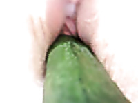 I am fucking myself with a big cucumber in the tight pussy