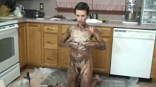 Slutty amateur woman plays with chocolate syrup in the kitchen