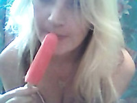 Blonde cutie sucks a popcicle and rubs her clit with it