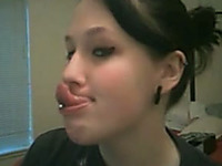 Nasty brunette teen shows her very long pierced tongue