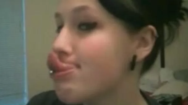 Nasty brunette teen shows her very long pierced tongue