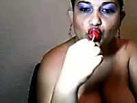 Mature lady with saggy breasts is licking her lollipop in a sexy way