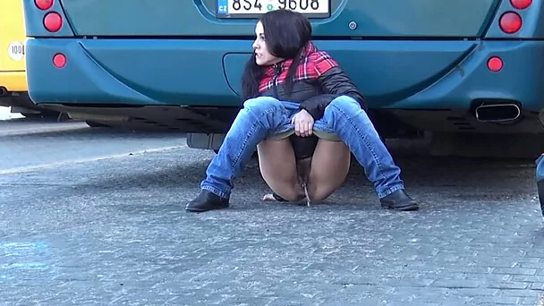 Dirty-minded brunette pulls down jeans to pee at the bus depot