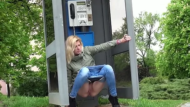 Blond haired chick pulls down jeans and piss in the phonebox