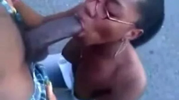 Four eyed ebony chick doesn't mind sucking a dick in public