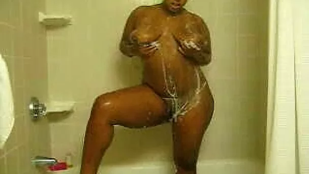 Awesome big bottomed chocolate nympho takes a shower and masturbates