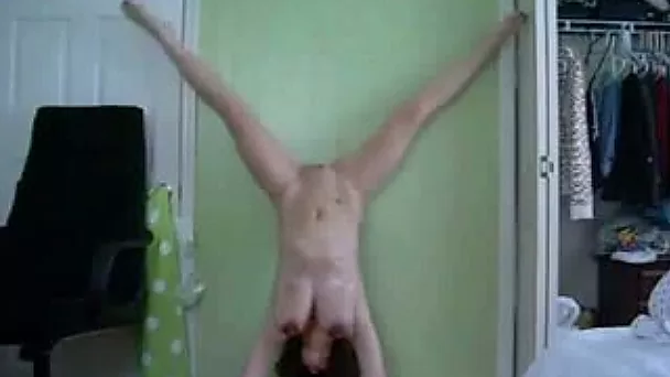 Dancing nude and doing some acrobatic tricks in front of a cam