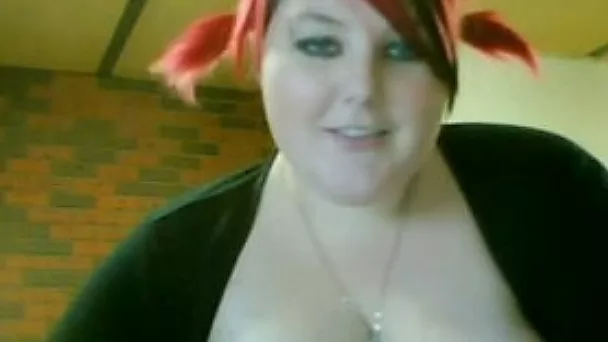 Lewd BBW with dyed hair shows her tits and meaty cunt on camera