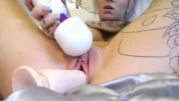 Just stunning tattooed auburn babe enjoys petting her twat with vibrator