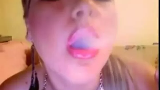 Blonde enchantress smokes a cig and teases with her lips and tongue