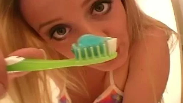 Kinky blondie called Denise brushes teeth and poses topless on bed