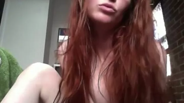 Long-haired gal in glasses dances and fingers her ass