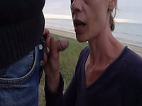 Cock blowing at the beach