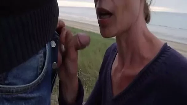 Cock blowing at the beach