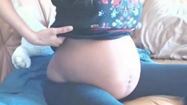 Chocolate skin preggo babe undresses and pleases herself