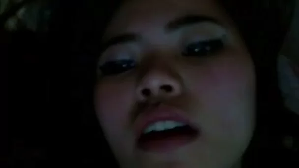 Cute oriental girlie enjoys tickling her own juicy tight pussy at night