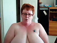 Short haired redhead mature webcam slut shows off her huge melons