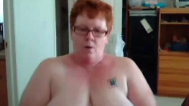 Short haired redhead mature webcam slut shows off her huge melons