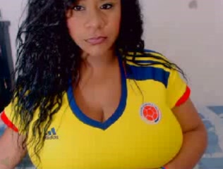 Mouthwatering Latina with curly hair show her bosom