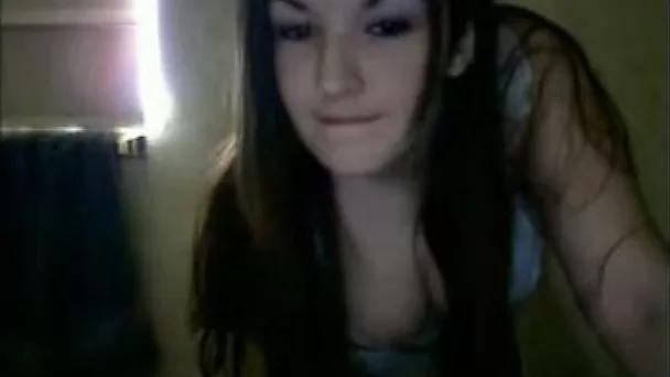 Busty amateur brunette stands topless on webcam in her bedroom
