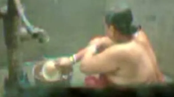 Amateur ugly Indian fatso tries to take a shower right outdoors