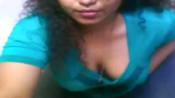 Curly amateur Indian brunette in blue T-shirt rubs her dark pussy