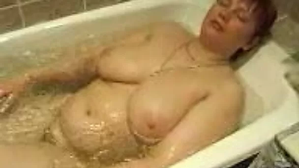 My mature lady with big tits taking hot tub all naked