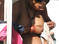 Amateur busty Indian lady in open air washing herself
