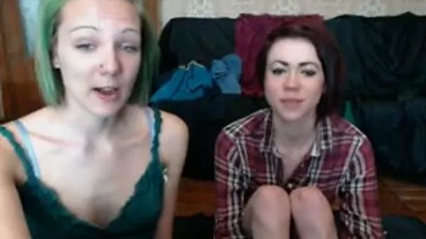 Pale red and green haired amateur lesbians tickle pussies on webcam