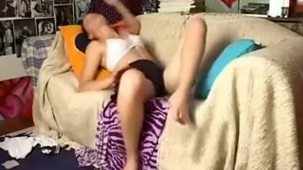 Cute brunette chick on the couch plays with her pussy