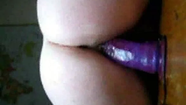 I am riding a huge dildo on the table and film myself