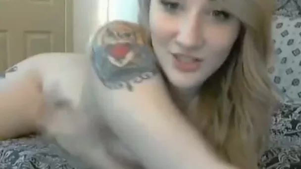 Tattooed pale skin teen blondie is already naked on webcam