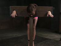Sweet white brunette with sexy ass restrained in pillory