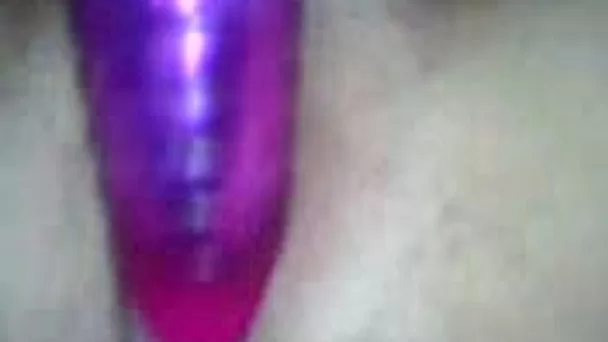 My neon purple sex toy penetrates closeup pussy