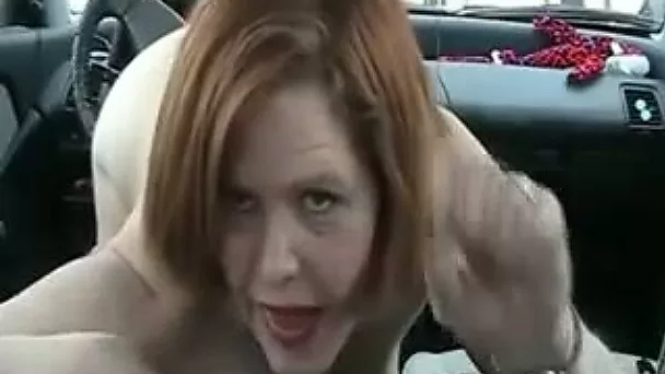 Huge boobed redhead whore riding car gear in front of me