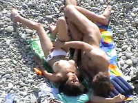 Torrid brunette MILF gives head to her boy on rocky beach
