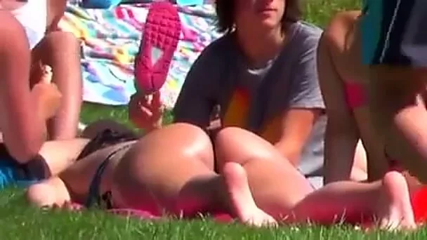 Filming sexy asses sun bathing on a loan at the picnic