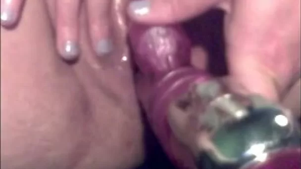 Tattooed mature slut poking her twat with big sex toy