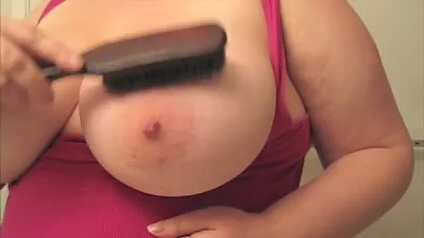 Wondrous big breasted slutty lady teased her melons with brush